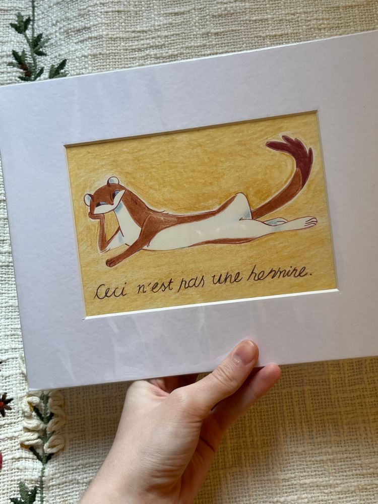 A matted pencil colour illustration of an anthropomorphic ermine lounging on a yellow background. Below it is the text “Ceci n’est pas une hermine” which translates to “This is not an ermine”. it is in reference to the famous painting “The Treachery of Images” by René Magritte