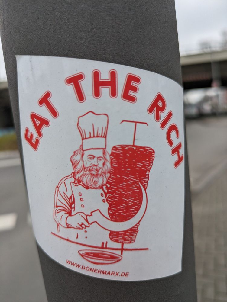 "eat the rich" Sticker an einer Laterne