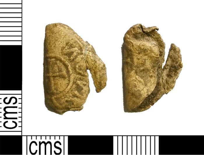 A damaged and bent lead disc: the obvers of a coin die is visible on one side