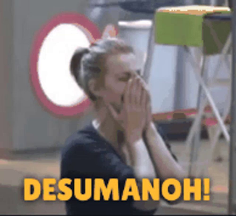 a woman covering her mouth with her hands and the words desumanoh written in yellow letters