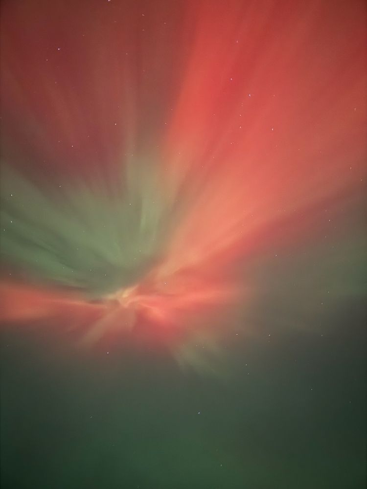 Red and green color burst of northern lights