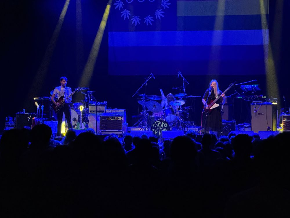 Three piece band Ekko Astral playing on stage with purple lighting at the Palace Theater in St. Paul.