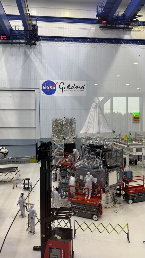 View into the NASA Goddard clean room at techs working on the Roman Space Telescope integrated payload assembly