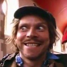 A photo of Sir Digby Chicken Caesar, wearing his trademark deerstalker hat with a manic look on his face.