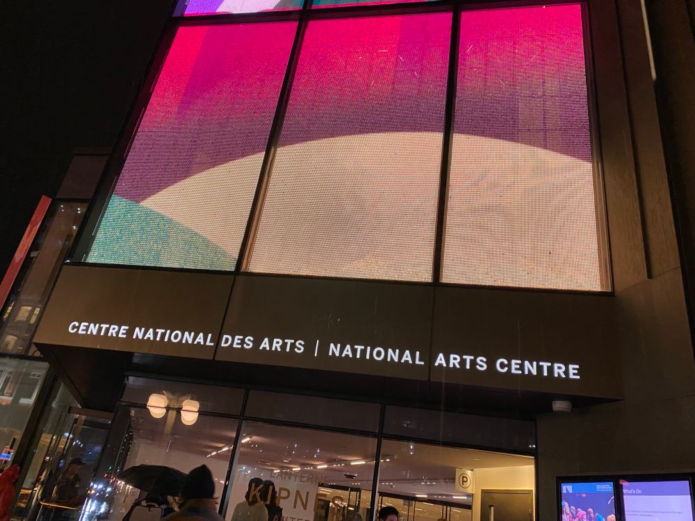 Establishing shot: The Kipness Lantern entrance in the rain. 