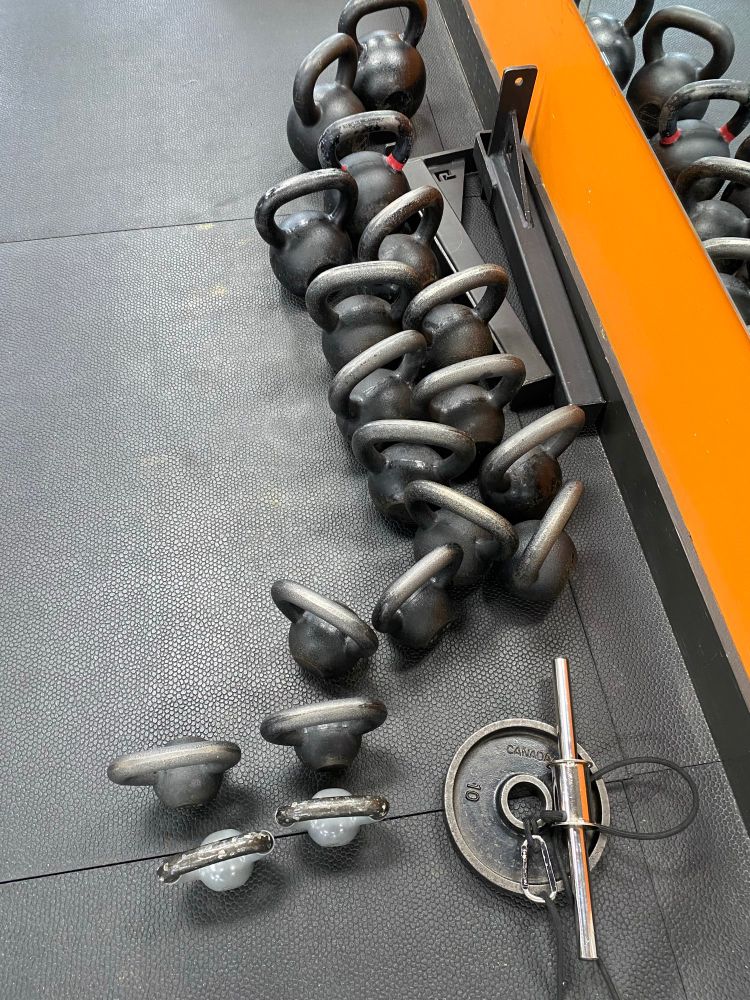 The kettle bells all pushed to one side instead of being neatly lined up. 