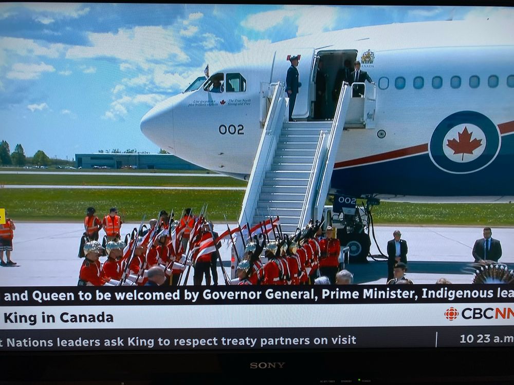 The King’s plane landed with the Royal Canadian Dragoons lined up to meet him. 