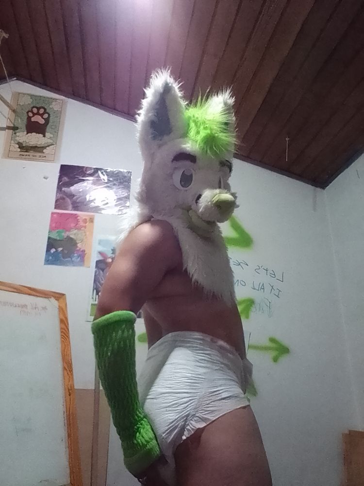 Fullshot of Nathan wearing only a diaper, their (new) furhead and green arm warmers