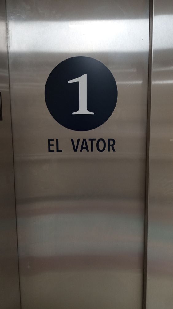Door of an elevator that has the number one on it and says EL VATOR