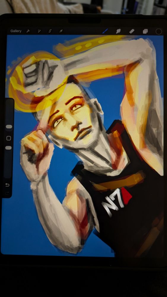 Photo of Procreate open on an iPad screen, showing a digital painting in progress of Commander Shepard. She is lying on her back, looking up at her Omni Tool, her other hand pointing at it. She wears a black tank top with the N7 logo clearly visible.