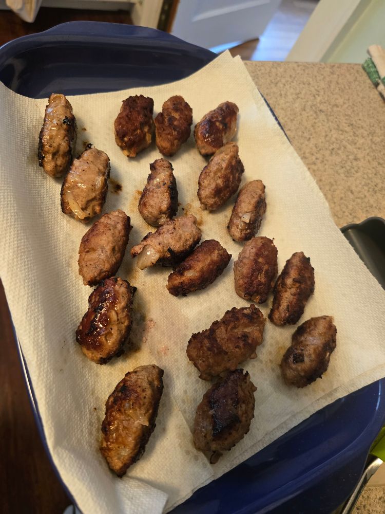 A tray full of cevapcici, or little Croatian sausages with onions inside