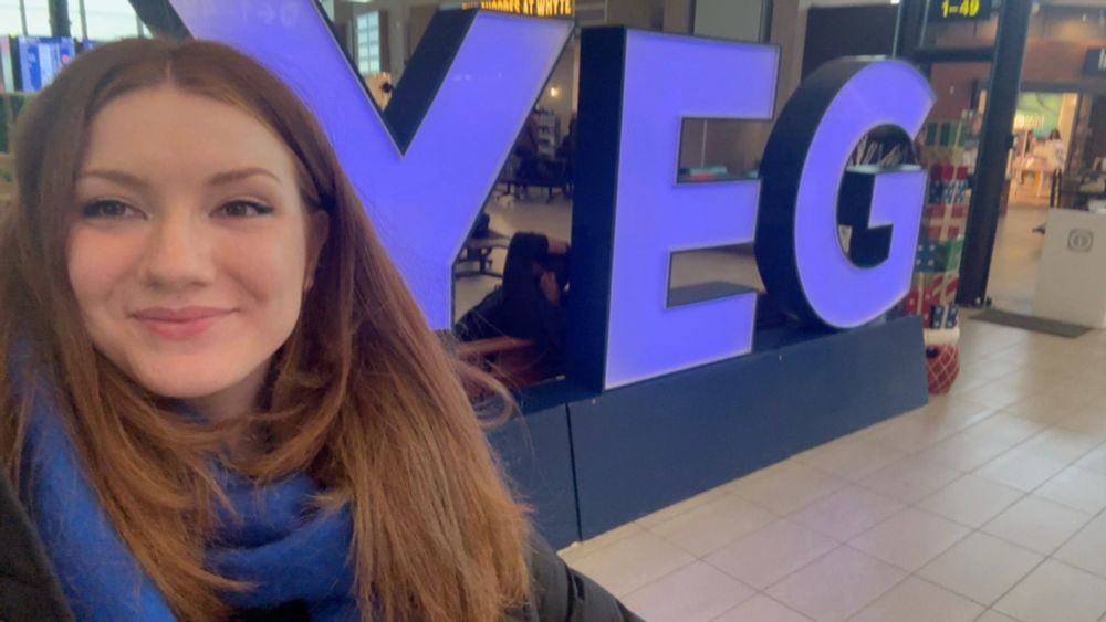 Selfie of myself in front of the YEG sign at the Edmonton airport :)