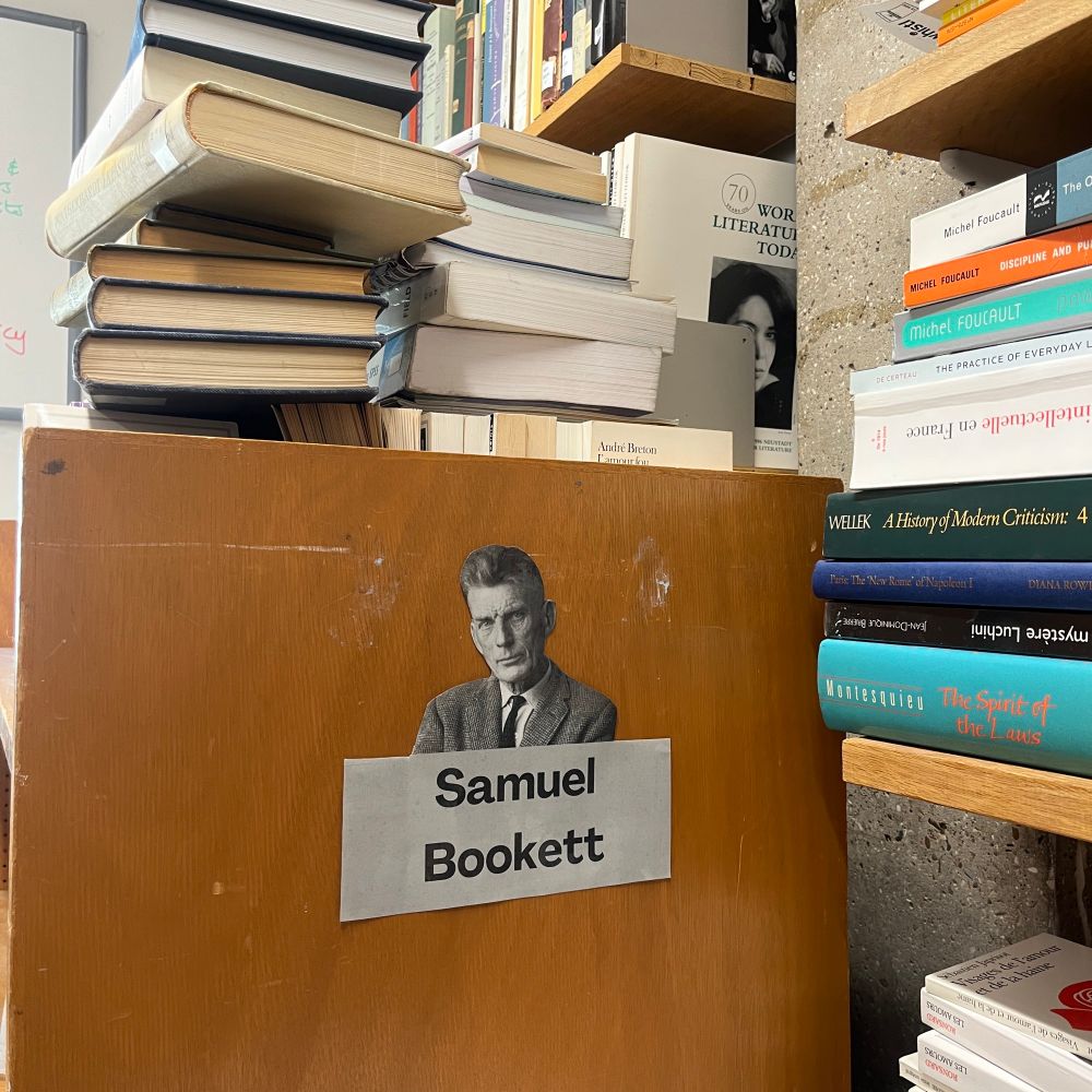 A book trolley with a label reading 'Samuel Bookett' is shown, with books piled on top.