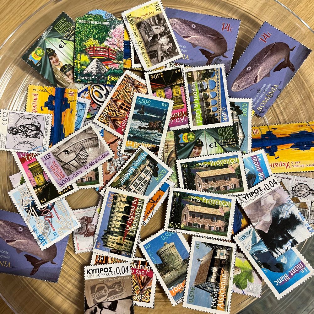 A plate of stamps with magnetic backing. The stamps are from various countries around the world - many show cultural landmarks or natural features.