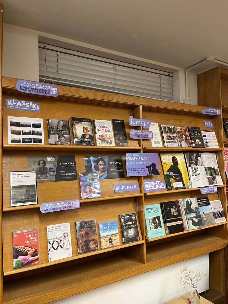 A photo of the exhibition space in the MMLL Library Foyer. On the bottom shelves are two rows of DVDs by women filmmakers, above are shelves highlighting the platform BFI Player and the journal Sight and Sound. One copy of Sight and Sound highlights Alice Diop, and another is open on a page about motherhood in films. On the top row of the display are more DVDs, as well as information about the  streaming platforms Klassiki and BoB.