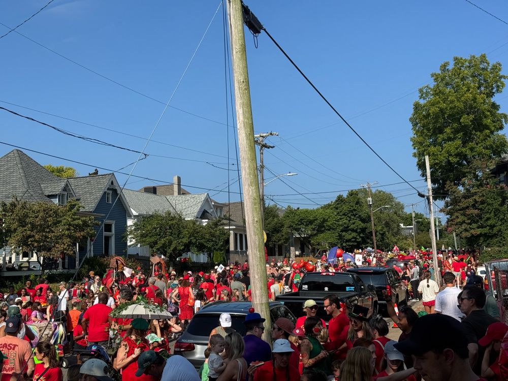 A photograph of Russell Street in East Nashville. The street is packed with people preparing to march in the parade. 