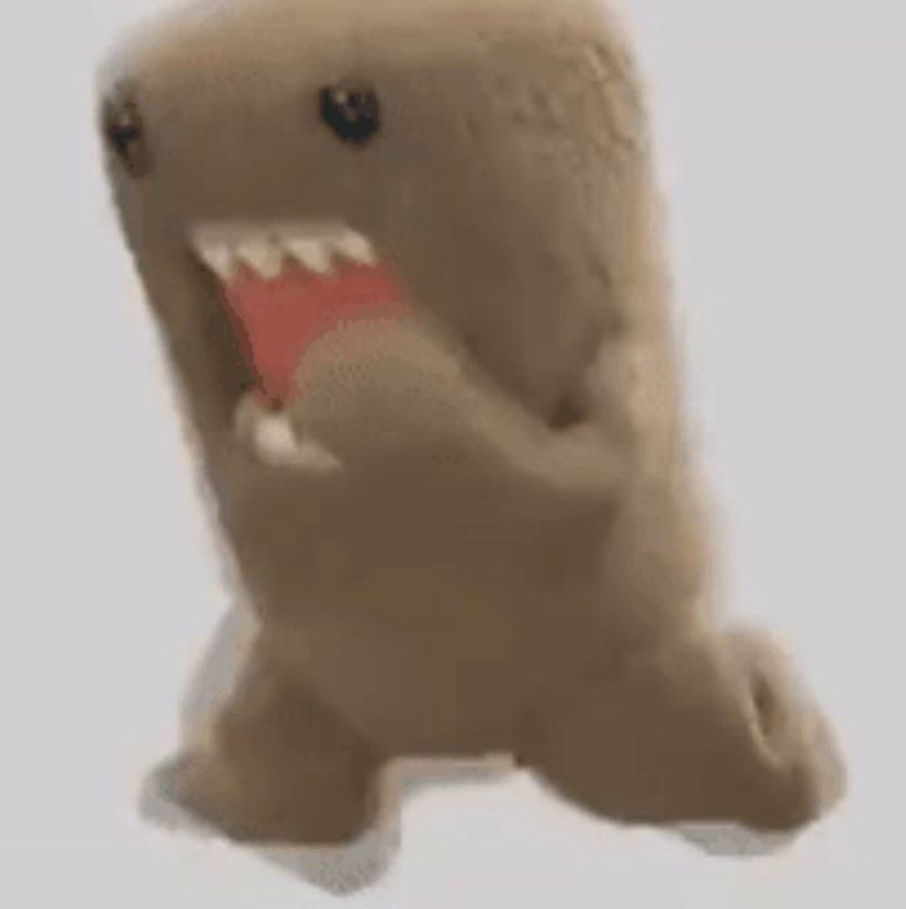 a stuffed animal with its mouth open looks like a shark