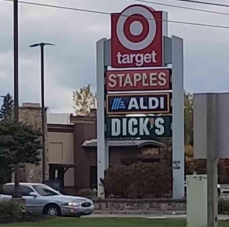 A series of business signs. Read, in order: Target Staples Aldi's Dicks