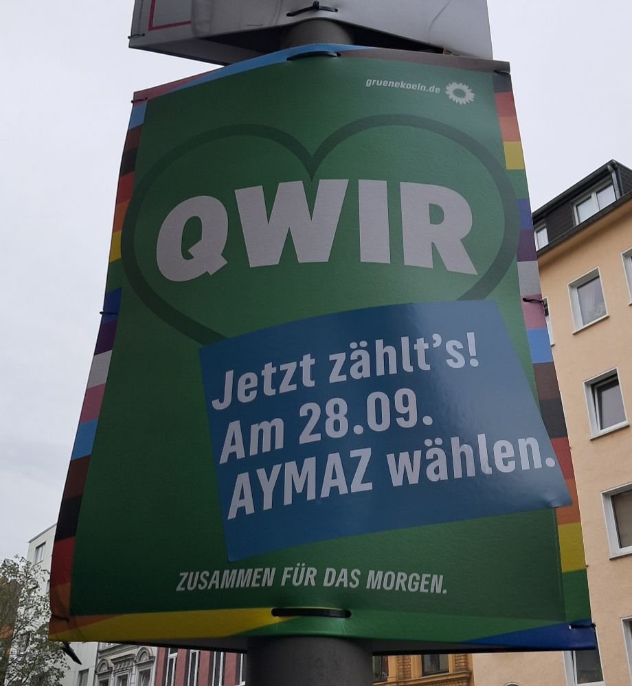 Wahplakat Kommunalwahl Köln der Grünen. In einem grünen Herz steht groß das Wort "QWIR"