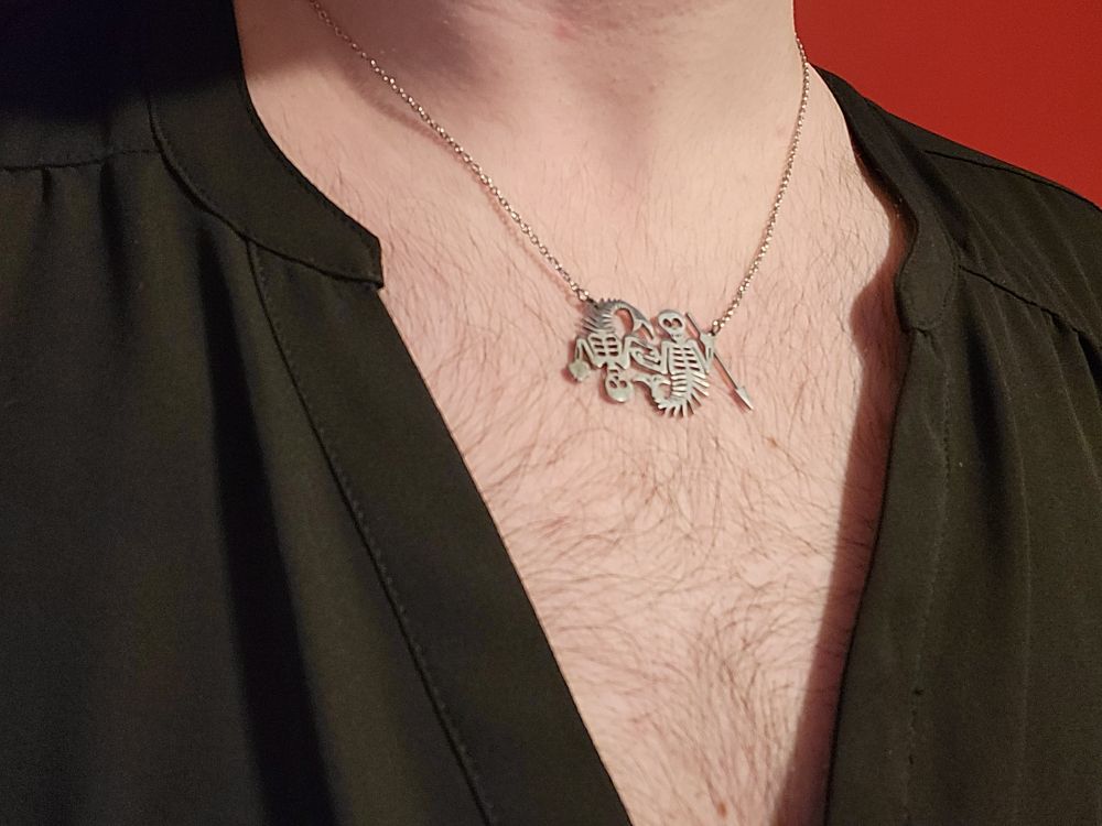 A close up of the same necklace, this time worn with a deep v-neck shirt