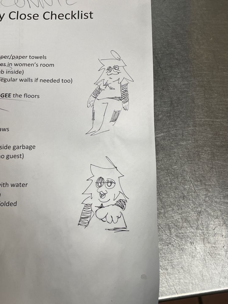 Photo of a paper with doodles in black pen on the right margin of Lith standing and another doodle pointing