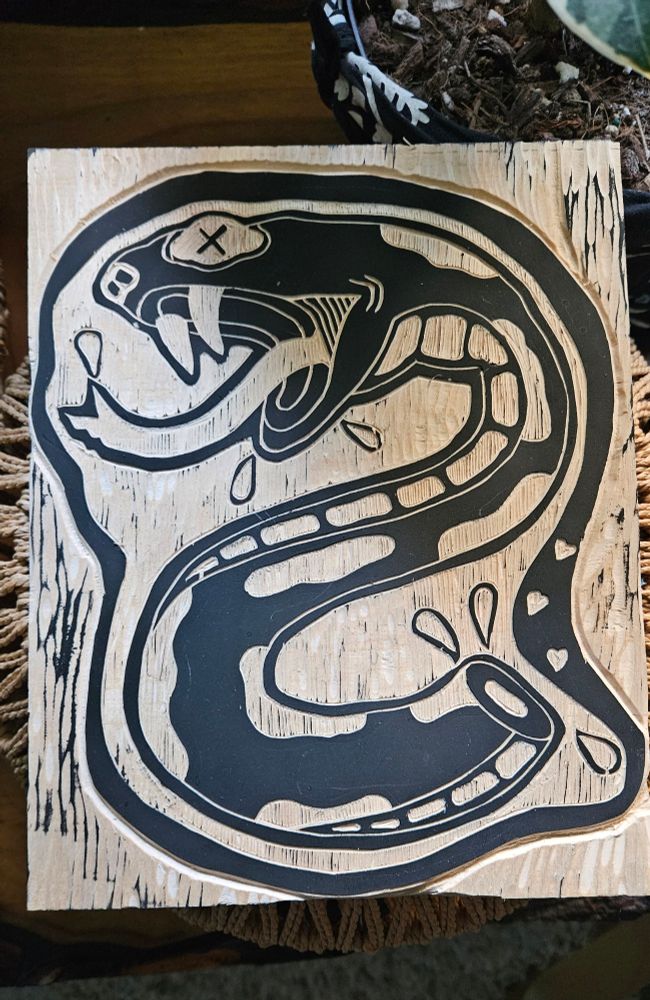Woodcut image of a snake that has been chopped in half