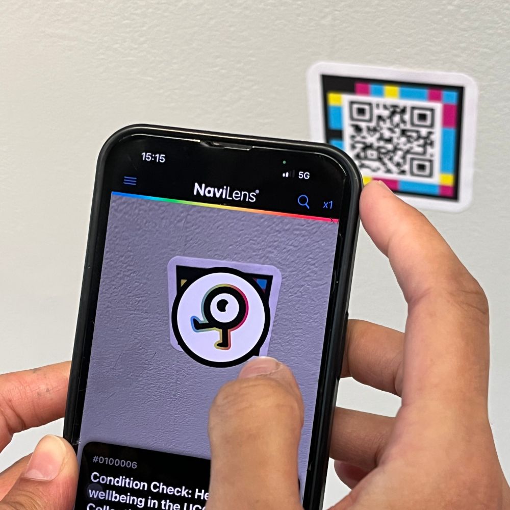 A person holding up a phone to scan a naivlens code inside the Glucksman
