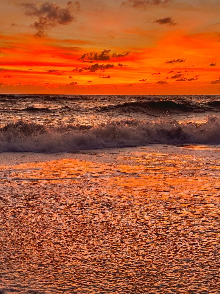 Deep orange hues of sunset afterglow over Gulf of Mexico