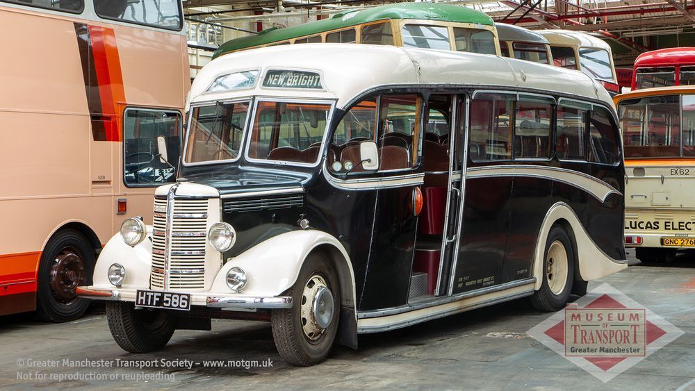 The same coach that is in the other picture is seen again, inside the museum of transport. It looks identical to the first photo, with a colour scheme of black and ivory, but this time the destination blind says New Brighton.