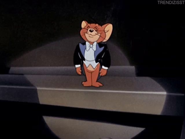 a cartoon of jerry in a tuxedo stands on a stage with a microphone