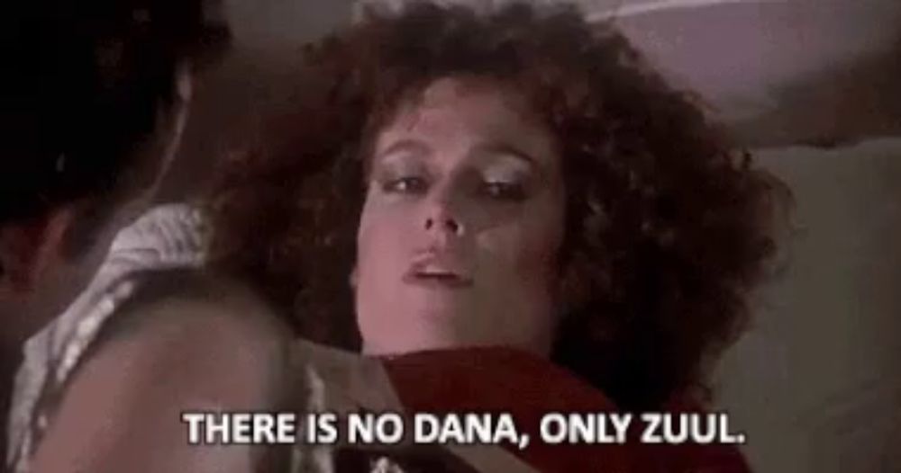 a woman is laying on a bed with a man and saying `` there is no dana , only zuul . ''