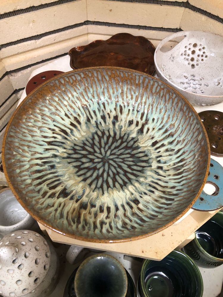 Ceramic bowl with carved interior and glaze breaking over the texture