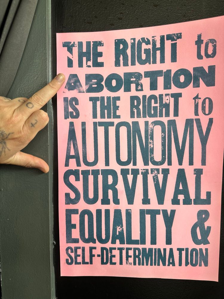 A pro abortion flyer hung behind the register at Cobra Burger. 