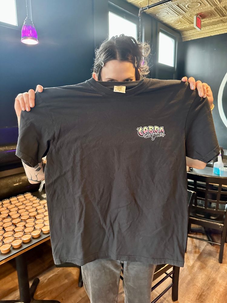 The front of the T-shirt with the words Cobra Burger in a stylized typeface