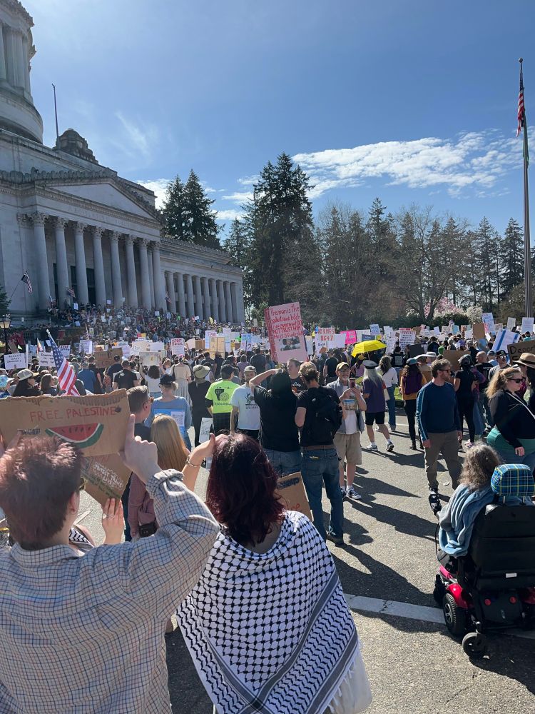 A large crowd assembled on the steps of the Washington State Capitol 