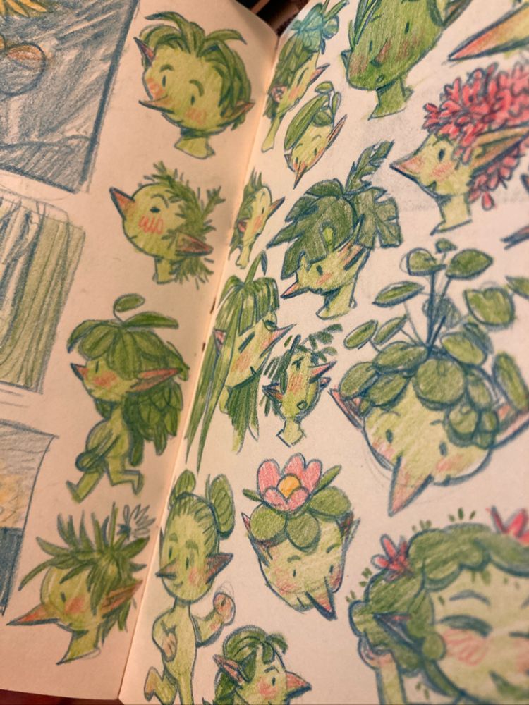 A sketchbook spread filled with drawings for cute little green characters with various plants growing out of their heads. Made by Anna Daviscourt.
