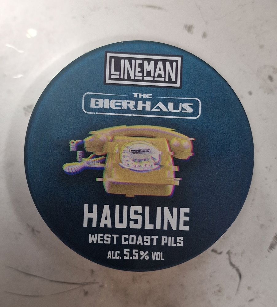 A Lineman HAUSLINE badge on top of a keg of beer