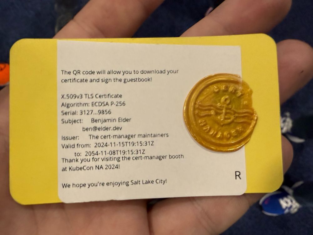 A small card with printed TLS cert metadata and a wax seal of the cert-manager logo