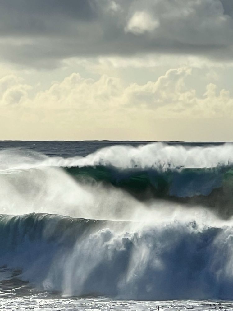 Dramatic lighting frames waves breaking in the first winter swell