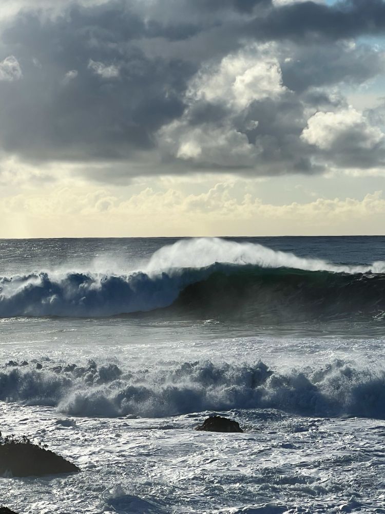 Dramatic lighting frames waves breaking in the first winter swell