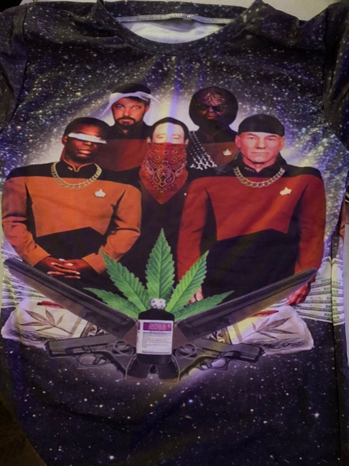 The crew of the USS Enterprise from Star Trek the Next Generation, edited to look like 1990s gangsters complete with bling, do rags, guns and marijuana.