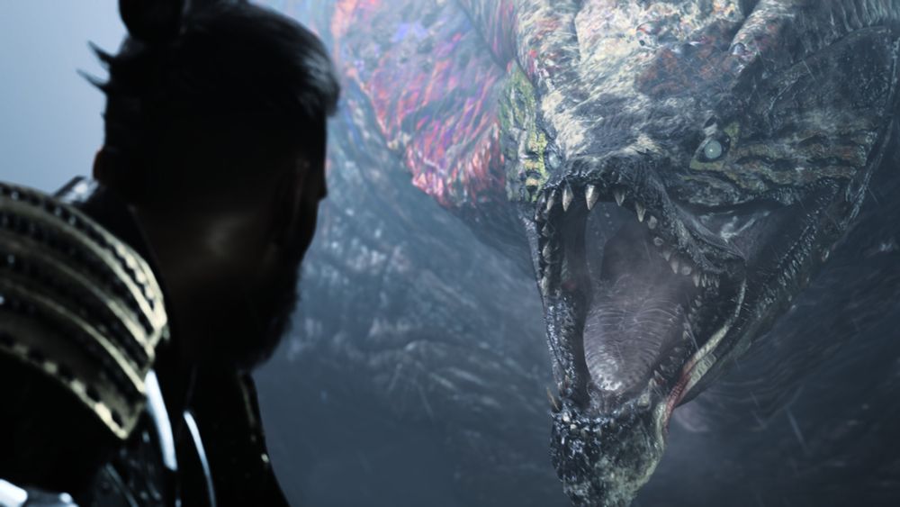 Monster Hunter Wilds screenshot. A hunter in the foreground faces a Uth Duna, a large monster inspired by a dragon and an arapaïma. The two have their face at the same level.