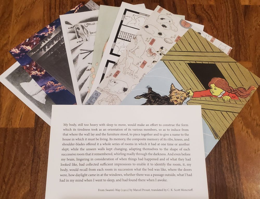 Splayed stack of postcards featuring public domain imagery on a table