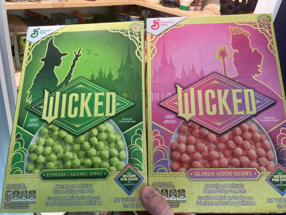 Boxes of Wicked breakfast cereal. Green Elphaba caramel apple and pink Glinda good berry. 