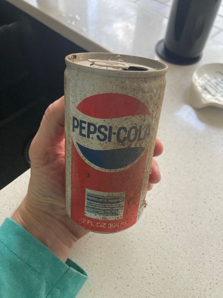 Old red and white aluminum can of Pepsi-Cola
