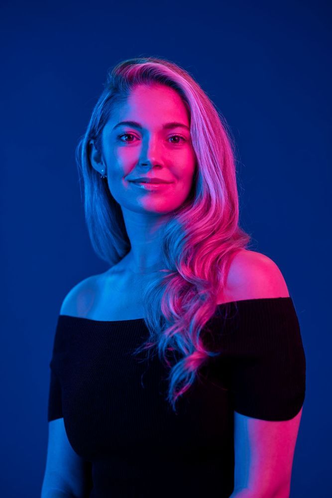 A portrait photo of Dr Julia Shaw with blue and pink light effects highlighting her face.