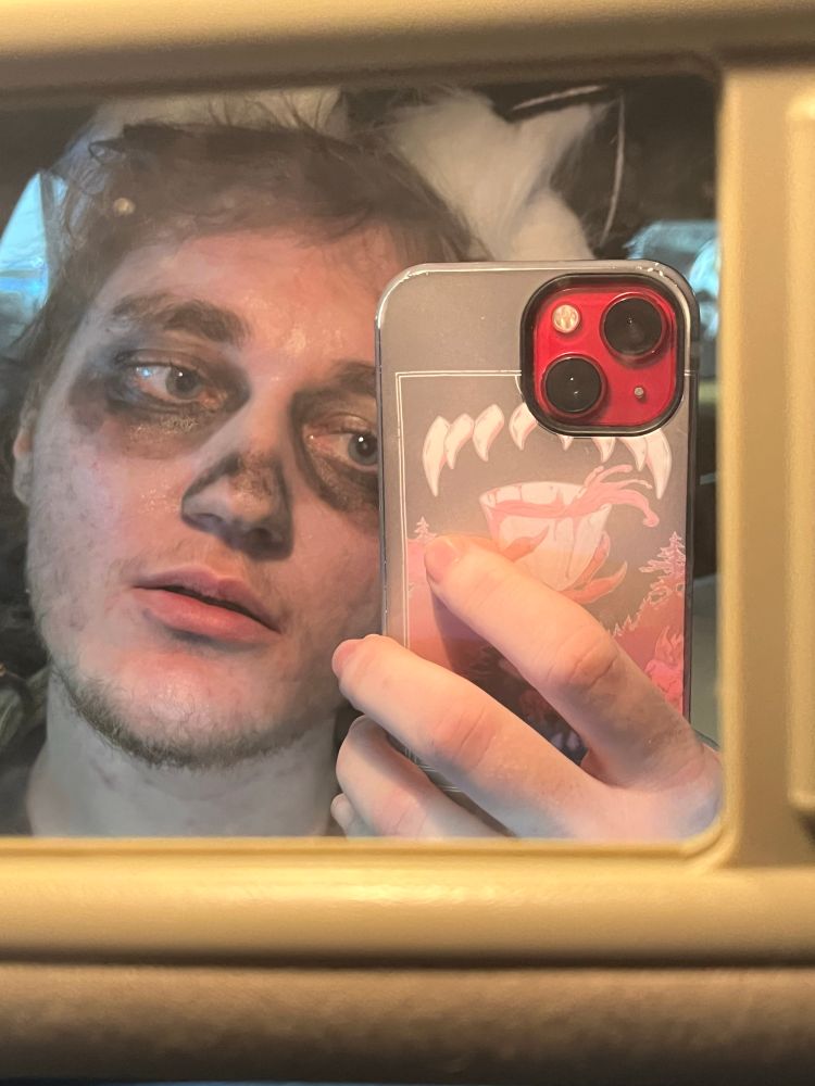 scruffy guy in smiledog makeup and huskie ears