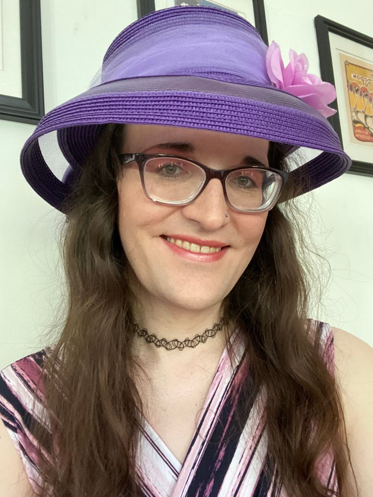 Purple hat with pink flower on right side