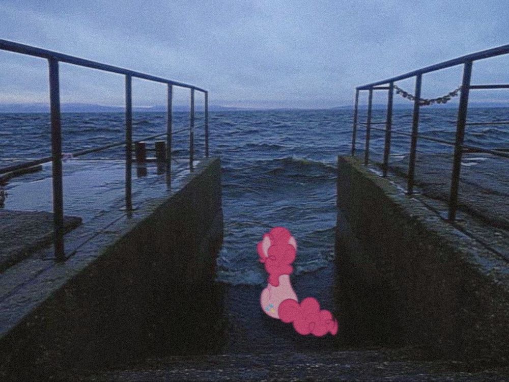 an edit of pinkie pie mlp facing away from the viewer sitting by an ocean near a concrete pier