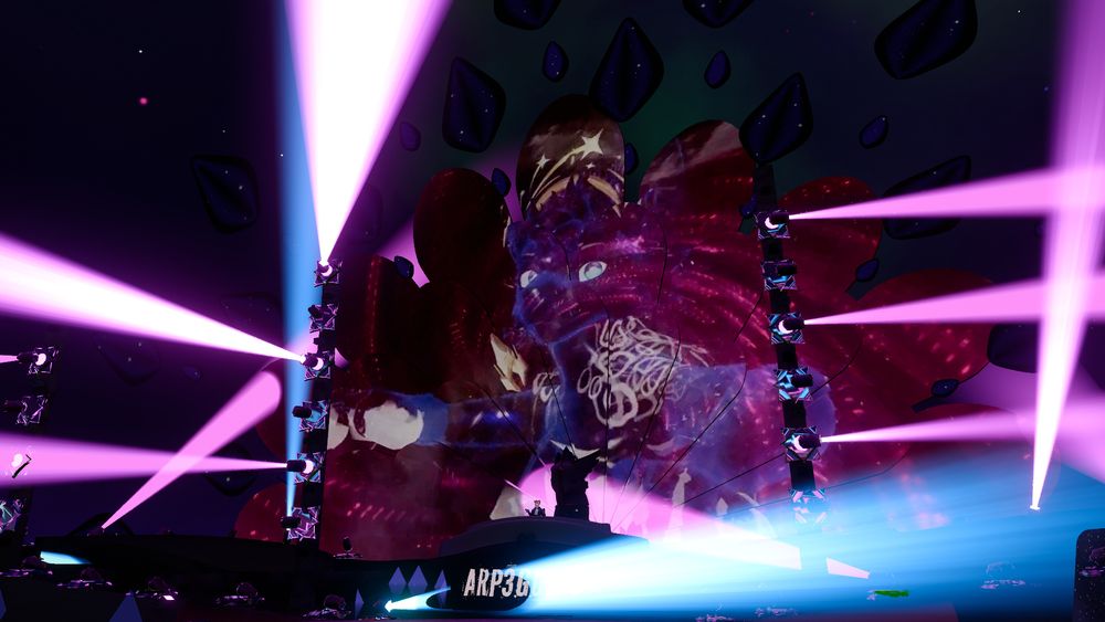 Furality Somna's Club F.Y.N.N. !  An enormous glowing avatar on the screens behind Arp in the DJ Booth